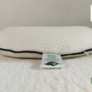 A comfortable and supportive latex pillow for sleeping, reading, or relaxing. The pillow is made from natural latex and has a breathable cover.