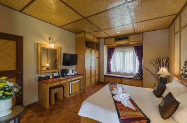 Une chambre d'hôtel confortable avec un grand lit, des meubles en bois et une belle vue.