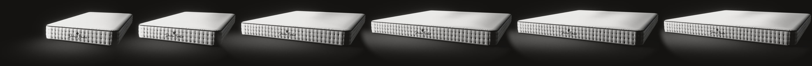 The mattress in its six sizes at one scale, side by side on a black floor, each seen three quarters from its foot end and 20 cm deep: Single, Twin, Queen, King, California King and Eastern King.